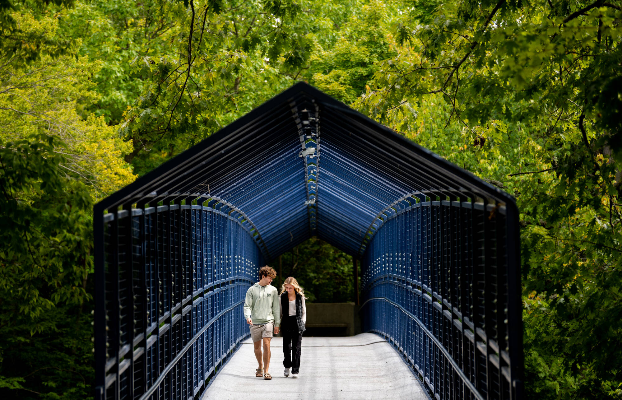 Asher Petersen, left, and Vanessa Grace walk across the Little Mac Bridge September 5. The two first-year students met during welcome week’s class photo at Lubbers Stadium. Petersen is studying mechanical engineering and Grace is studying medical dia...